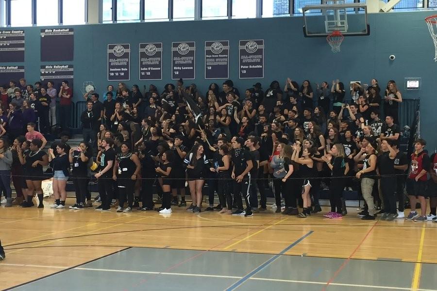 Seniors%2C+dressed+in+black%2C+lead+cheers+against+other+classes+in+the+gym+during+the+Eagle+Games.