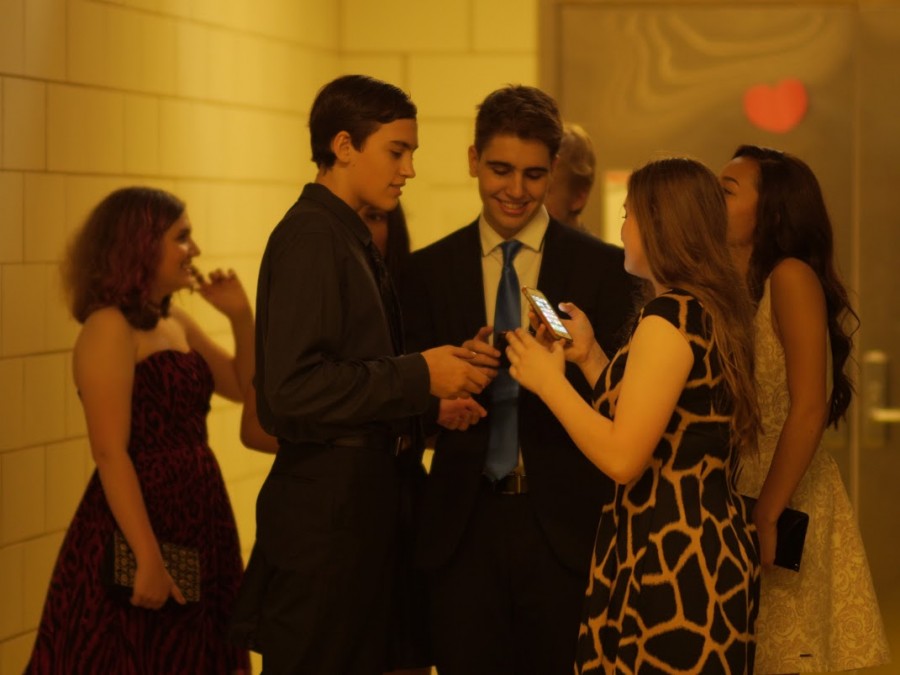 Lucas Steinbruegge and Nasko Pelinkaj, both 18, chatting with friends while choosing to attend Homecoming without dates.  A common occurrence here, going to Homecoming with friends is encouraged more than bringing a date. This year, prom will be held on May 21, 2016, in the Harold Washington Library.                                                                                  