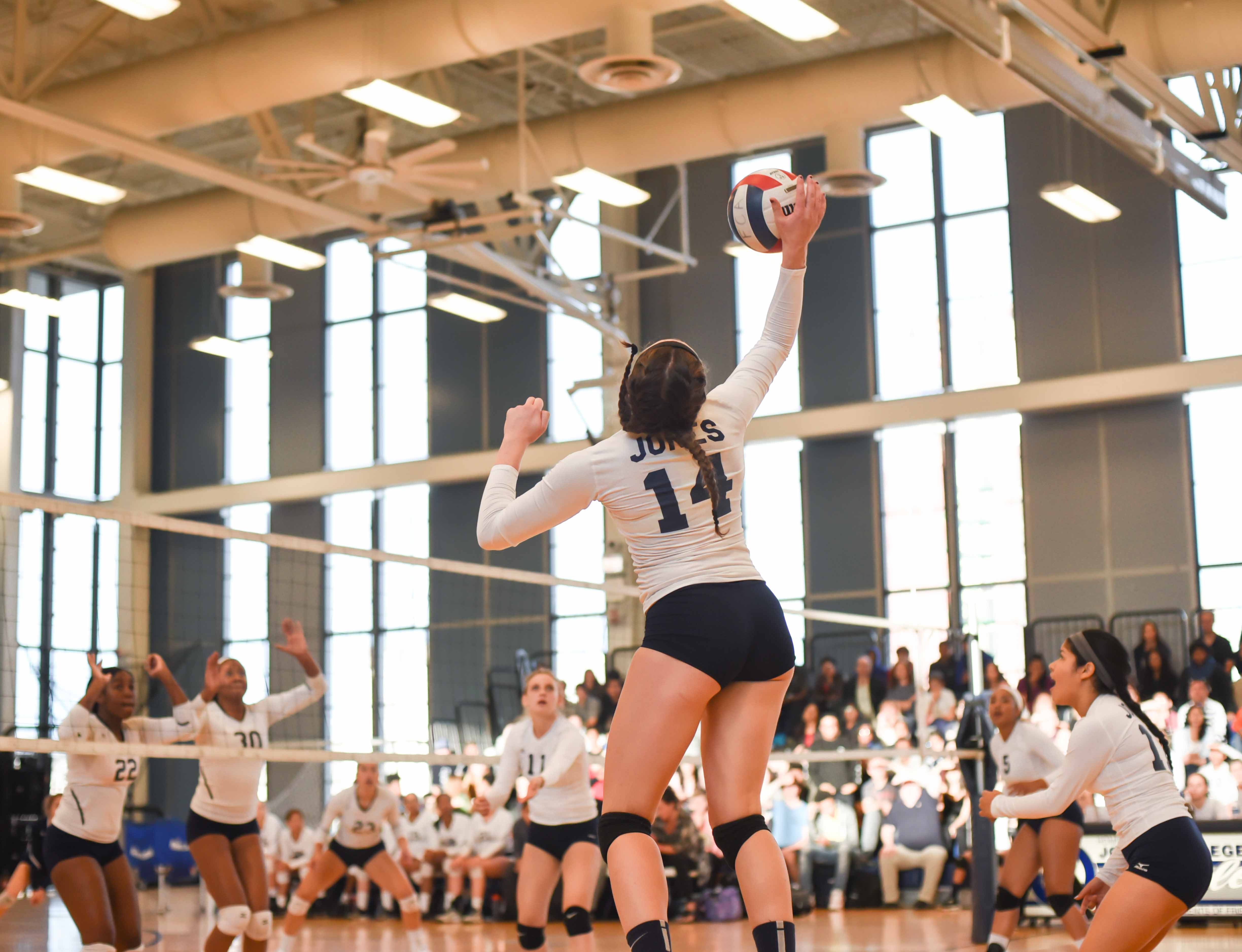 Kaila Kasper '17 hits a kill over blockers in the second set.