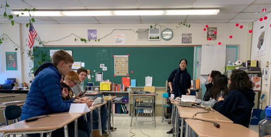 The JV team (right), led by coach and chemistry teacher Heidi Park, sets up for a match.