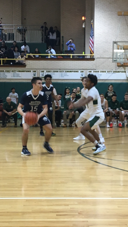 Niko Rosich ‘21 passes the ball at the top of the key. 