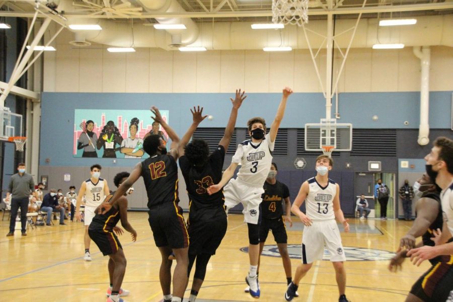 Tommy Cleland 21 goes up for a layup in a game against Lindblom 