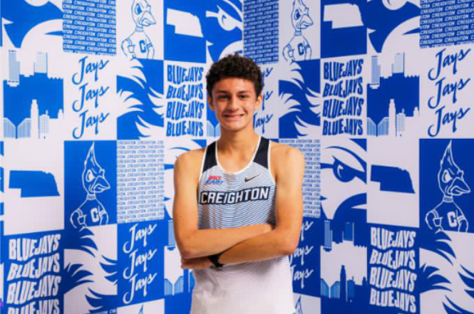 Sam Berlinghof ‘24 poses in the uniform of Creighton University, where he will be running in college.