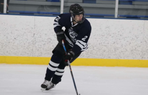SKATER Ian Karas ‘25 shown on the ice during a Chicago South Hockey game.