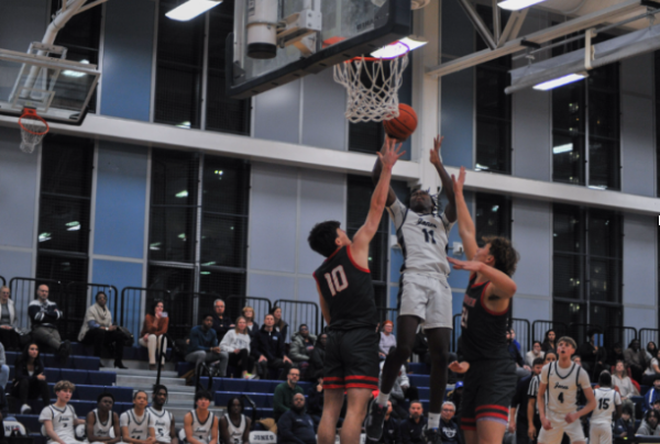 Playing: Aaron Laroche-Dogbe ‘26 shooting during win against Amundsen High School. Photo credit: Sam Tidmarsh ‘26 -  Instagram: @sams.shutters.
