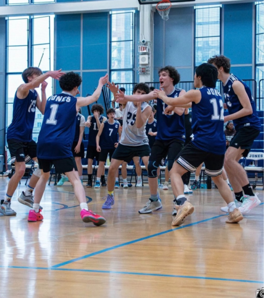 The Jones boys volleyball team celebrating after a big win.