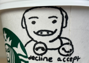 A Starbucks cup with a “John Pork” illustration.