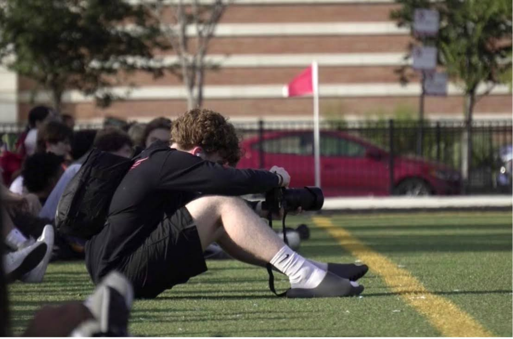 Zach Eversmann ‘27 taking photos of the boys soccer team.