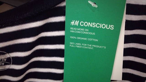 A clothing tag from H&M's "Conscious Choice" line on a garment. The brand was accused of greenwashing for deceptive marketing.